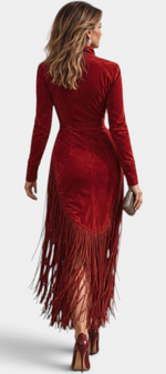 Mahaute red velvet midi dress with long fringe hem and long sleeves, back view on a woman wearing heels.