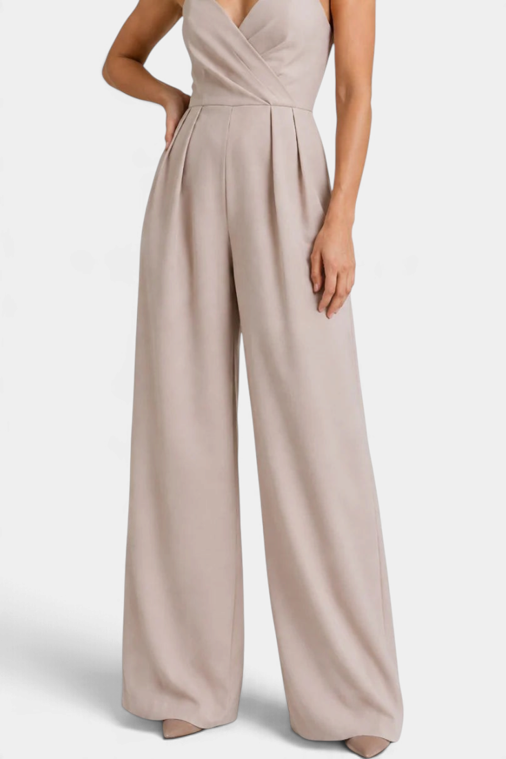 Mahaute Romilly beige wide-leg jumpsuit with a wrap-front bodice, thin straps, and pleated waist for an elegant look.