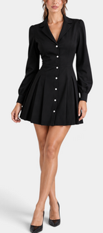 Mahaute Ruzha black short shirt dress with a cinched waist, button-front, and pleated skirt worn by a model.
