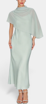 Mahaute midi satin dress in sage green featuring an elegant draped neckline and a flowing asymmetrical cape overlay.