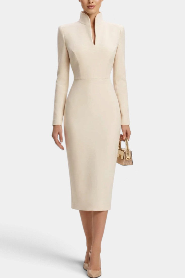 Mahaute Sandy beige midi dress with long sleeves, fitted waist, and a modern split mock neck on a model