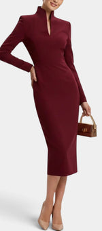 Mahaute Sandy burgundy midi dress with a high split neckline and long sleeves worn by a model with nude heels.