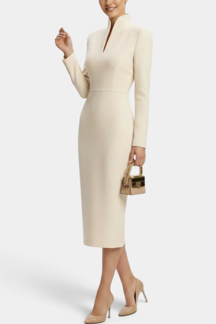 Mahaute Sandy cream midi dress with long sleeves, high slit neckline, and fitted silhouette on a model.