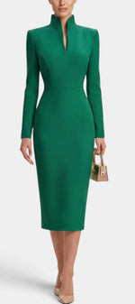 Mahaute Sandy emerald green midi dress with a high split collar and long sleeves on a model wearing nude heels.