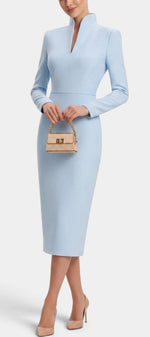 Mahaute Sandy light blue midi dress with a high split collar, long sleeves, and a fitted silhouette.
