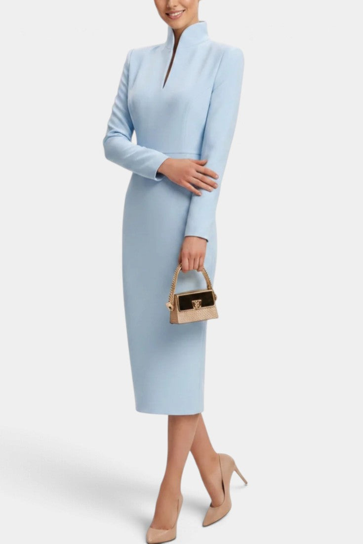 Mahaute Sandy light blue midi dress with a high split collar and long sleeves worn with nude heels and a small bag