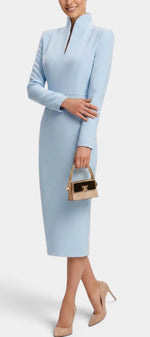 Mahaute Sandy light blue midi dress with a high split collar and long sleeves worn with nude heels and a small bag
