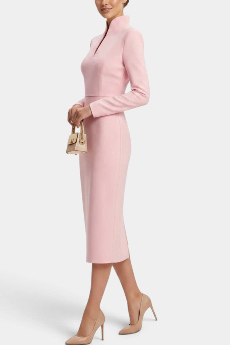 Mahaute Sandy light pink midi dress with a high slit collar and long sleeves worn by a model with nude heels.
