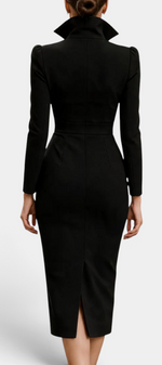 Back view of Mahaute Siyana black midi dress with structured high collar, cinched waist, and back slit.