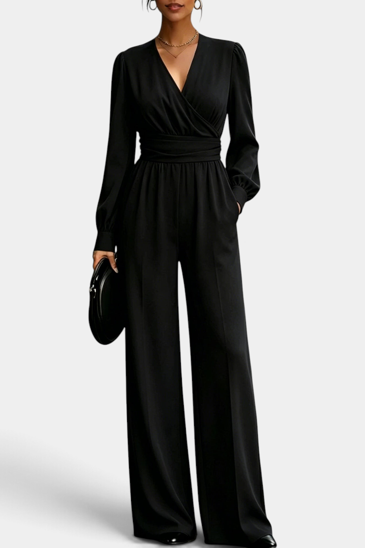 Mahaute Sophronia black long-sleeve jumpsuit featuring a wrap V-neck, draped waist, and elegant wide-leg trousers.