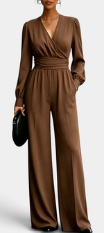 Mahaute Sophronia brown long-sleeve jumpsuit with a wrap-front V-neck, draped waist, and wide-leg trousers.