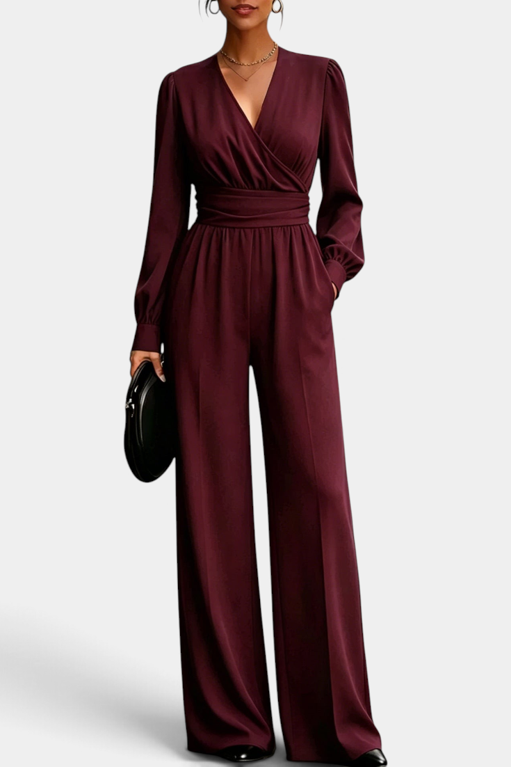 Mahaute Sophronia burgundy long-sleeve jumpsuit with a wrap-front V-neck, draped waist, and wide-leg trousers.