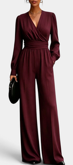 Mahaute Sophronia burgundy long-sleeve jumpsuit with a wrap-front V-neck, draped waist, and wide-leg trousers.