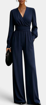 Mahaute Sophronia navy blue long-sleeve jumpsuit with a wrap V-neck, draped waist, and wide-leg trousers.