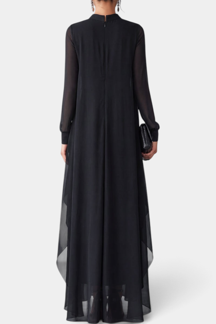 Back view of Mahaute Sophronie long black dress with high neckline, sheer long sleeves, and flowing asymmetrical drapes