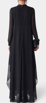 Back view of Mahaute Sophronie long black dress with high neckline, sheer long sleeves, and flowing asymmetrical drapes