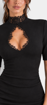 Mahaute Stanimira black fitted short dress featuring a high lace neckline and a bold chest cutout detail.