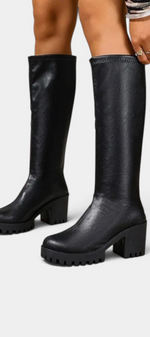 Mahaute Suny black knee-high boots with a chunky block heel and thick lug sole for a modern urban look.