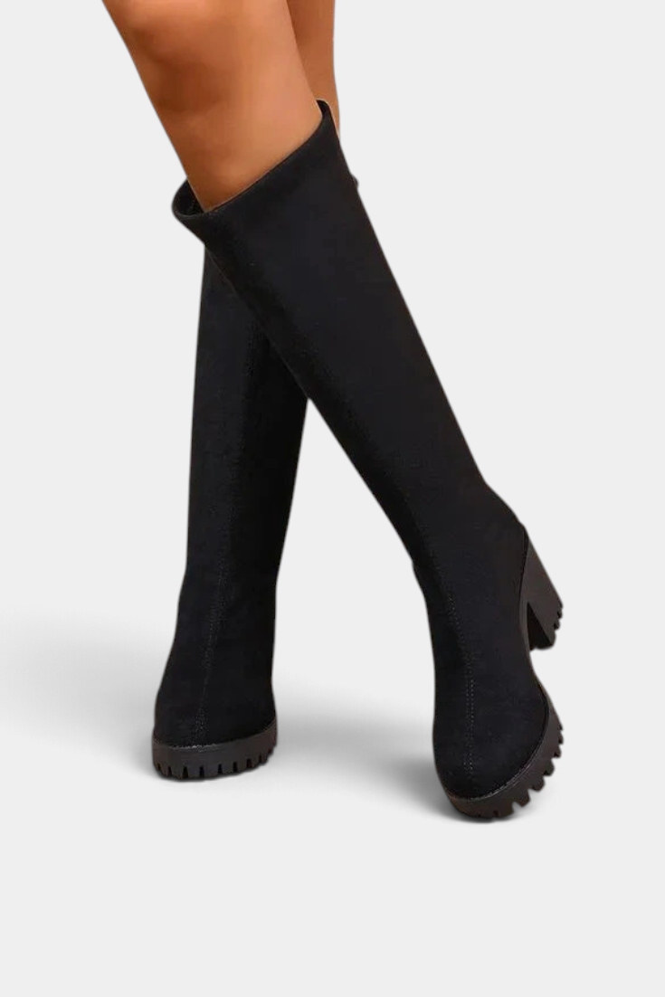 Mahaute Suny black knee-high boots with a structured shaft, block heel, and thick lug sole.