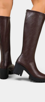 Mahaute Suny brown knee-high boots with block heel and chunky lug sole, featuring a back zipper closure.