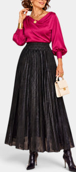 Mahaute Tegan high-waisted black metallic pleated maxi skirt worn with a magenta blouse and black ankle boots.