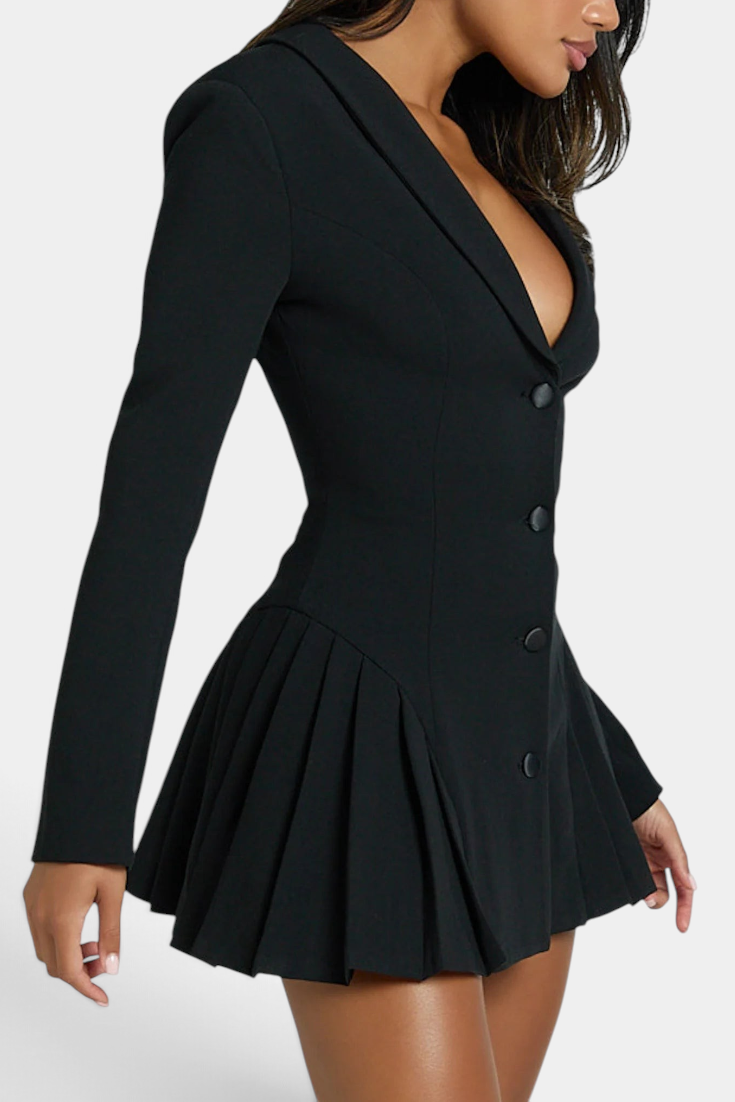 Mahaute Thelma black blazer dress with deep V-neck, cinched waist, and pleated skirt on a model