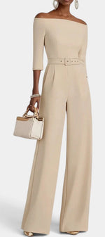 Mahaute Tisdale beige off-shoulder jumpsuit with three-quarter sleeves, belted waist, and wide-leg trousers.