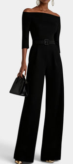 Mahaute Tisdale black off-shoulder jumpsuit with three-quarter sleeves, belted waist, and wide-leg trousers.
