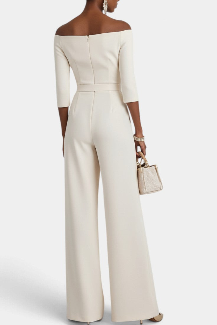Back view of Mahaute Tisdale off-shoulder cream jumpsuit with wide-leg trousers and belted waist on a model