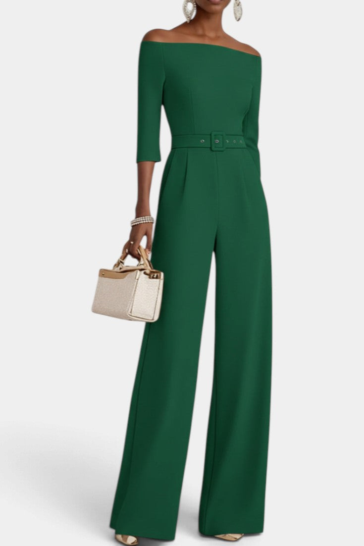 Mahaute Tisdale emerald green off-the-shoulder jumpsuit with a belted waist, three-quarter sleeves, and wide legs.