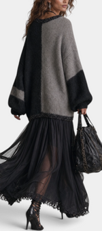Mahaute long two-tone knit and voile dress with lace trim, V-neck, and flowing skirt worn by a model in motion.