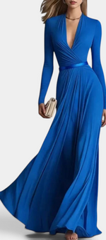 Mahaute Veselina long blue wrap dress with long sleeves, draped bodice, and belted waist for an elegant evening look.