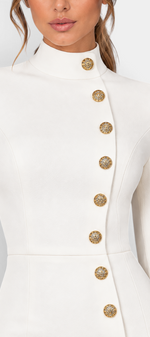 Mahaute Vihra cream midi dress featuring a structured high neck and asymmetrical gold embossed buttons