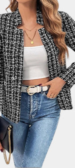 Mahaute Visenta short black and white tweed jacket with a structured collar worn over a white top and blue jeans