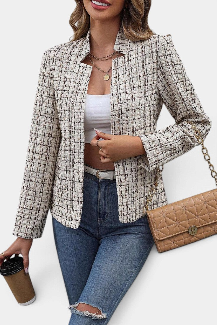 Mahaute Visenta short structured tweed jacket in beige with a shirt collar worn over a white top and blue jeans.
