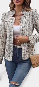 Mahaute Visenta short structured tweed jacket in beige with a shirt collar worn over a white top and blue jeans.