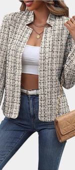 Mahaute Visenta cropped tweed jacket in cream and black with a structured collar worn over a white crop top and jeans