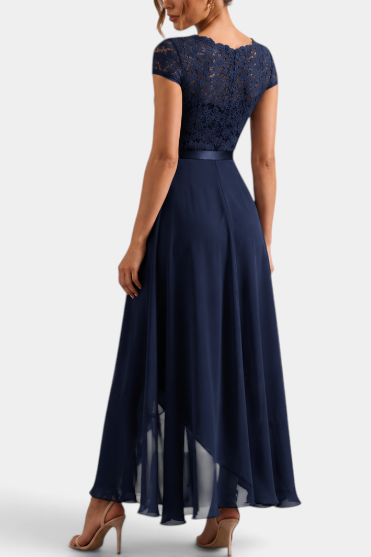 Mahaute Vittoria navy blue asymmetrical long dress with floral lace bodice and short sleeves, back view.