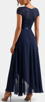 Mahaute Vittoria navy blue asymmetrical long dress with floral lace bodice and short sleeves, back view.