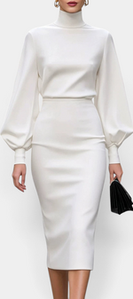 Mahaute Celandine white midi pencil dress with a high neck and voluminous balloon sleeves, worn in a city setting.