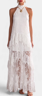 Mahaute white lace maxi dress with high neck, ruffled layers, and sheer floral details worn by a model