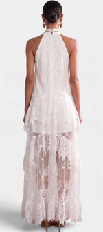 Back view of a model wearing a Mahaute white lace maxi dress with a high neck, ruffles, and sheer detailing.