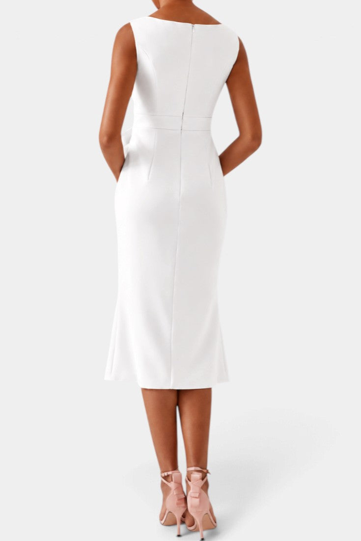 Back view of a Mahaute white midi dress with a boat neckline and fitted silhouette worn with pink heels