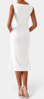 Back view of a Mahaute white midi dress with a boat neckline and fitted silhouette worn with pink heels