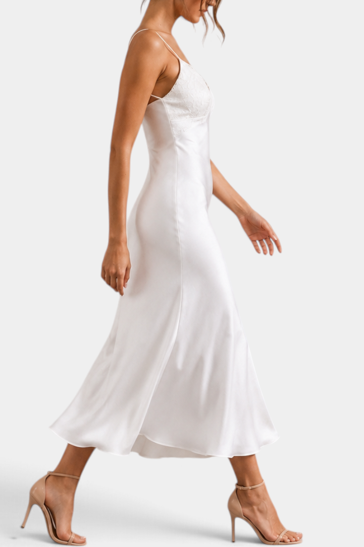 Mahaute long white satin slip dress with lace V-neckline and thin straps worn by a model in heels