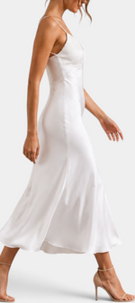 Mahaute long white satin slip dress with lace V-neckline and thin straps worn by a model in heels