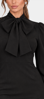 Mahaute Yordanka black midi dress featuring a sophisticated pussy-bow neckline and elegant puff sleeves.