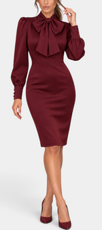 Mahaute Yordanka burgundy midi dress with pussy-bow collar, long puff sleeves, and fitted silhouette on a model.