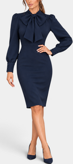 Mahaute Yordanka navy blue midi dress with a pussy-bow collar, long puff sleeves, and buttoned cuffs.