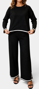 Mahaute Ysella black knit lounge set with long-sleeve top and wide-leg trousers featuring white contrast trim details.